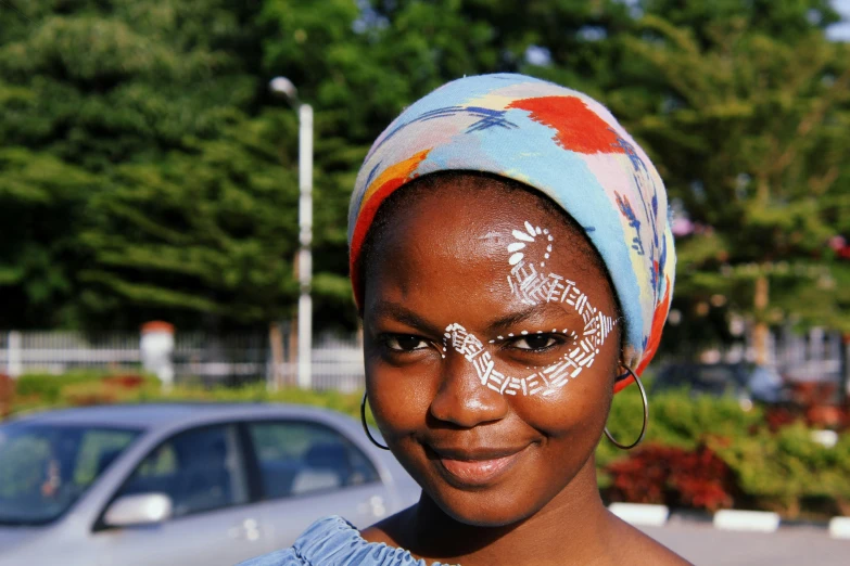 a woman with face paint on her forehead