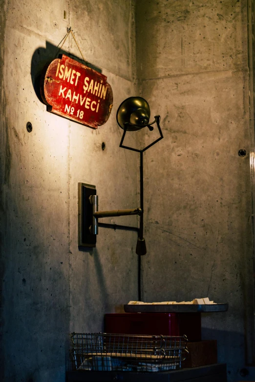 a sign attached to the wall near a lamp
