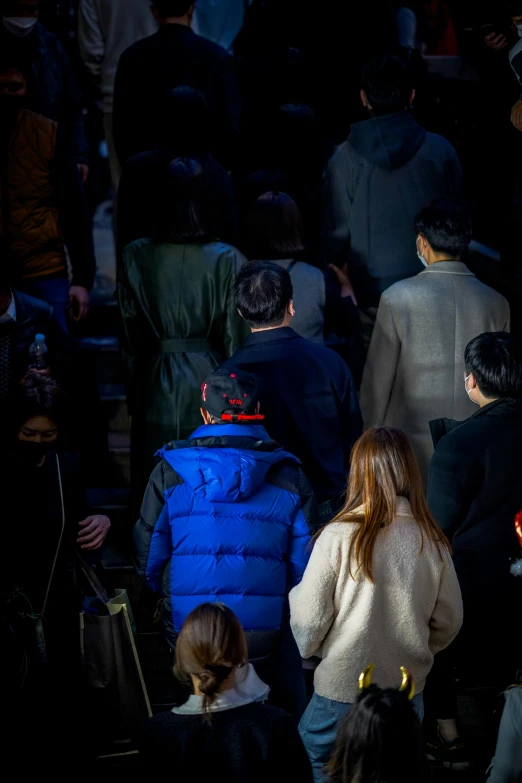 a group of people are walking on a crowded street