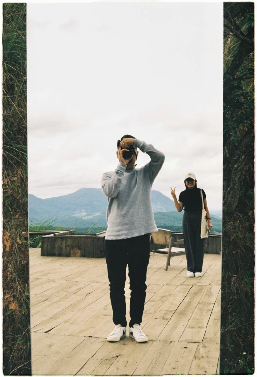 two people are standing on a deck, with one looking up