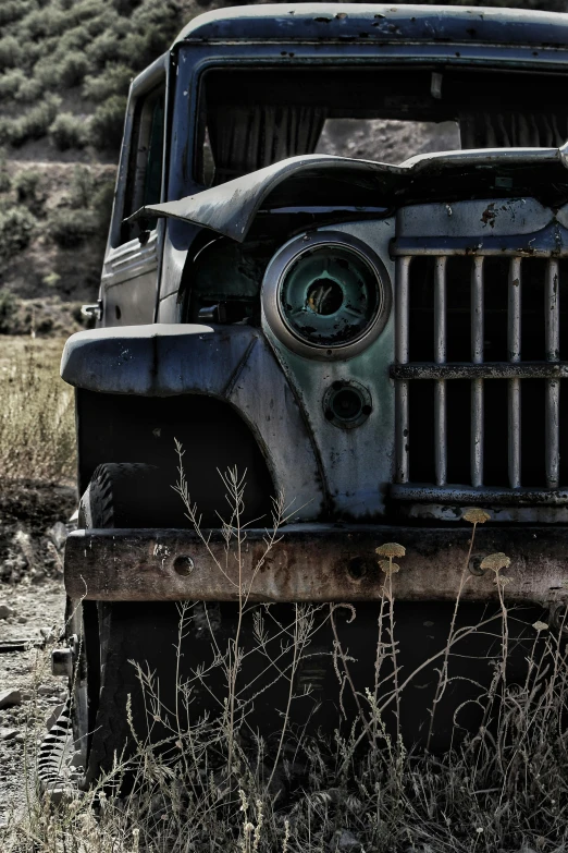 an old jeep in the field with no one around