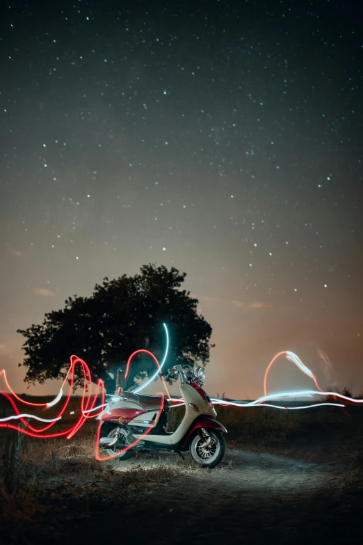 a motorcycle sits parked with its lights blurry