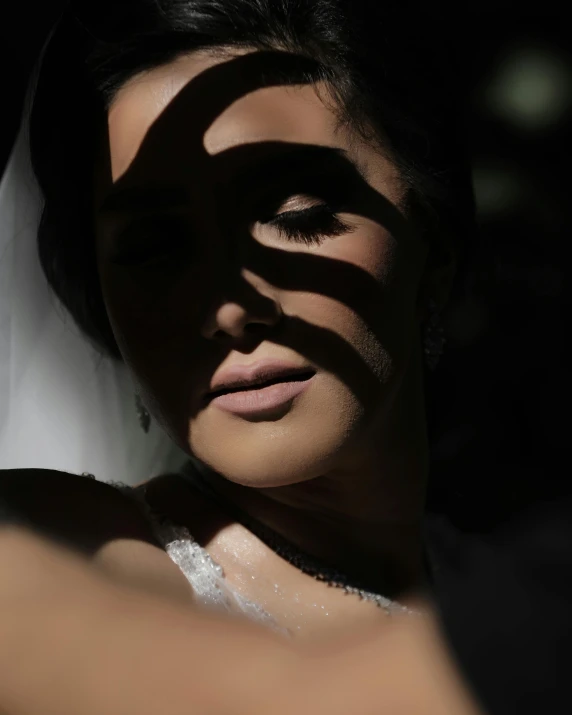 a woman with her eyes open wearing a wedding dress