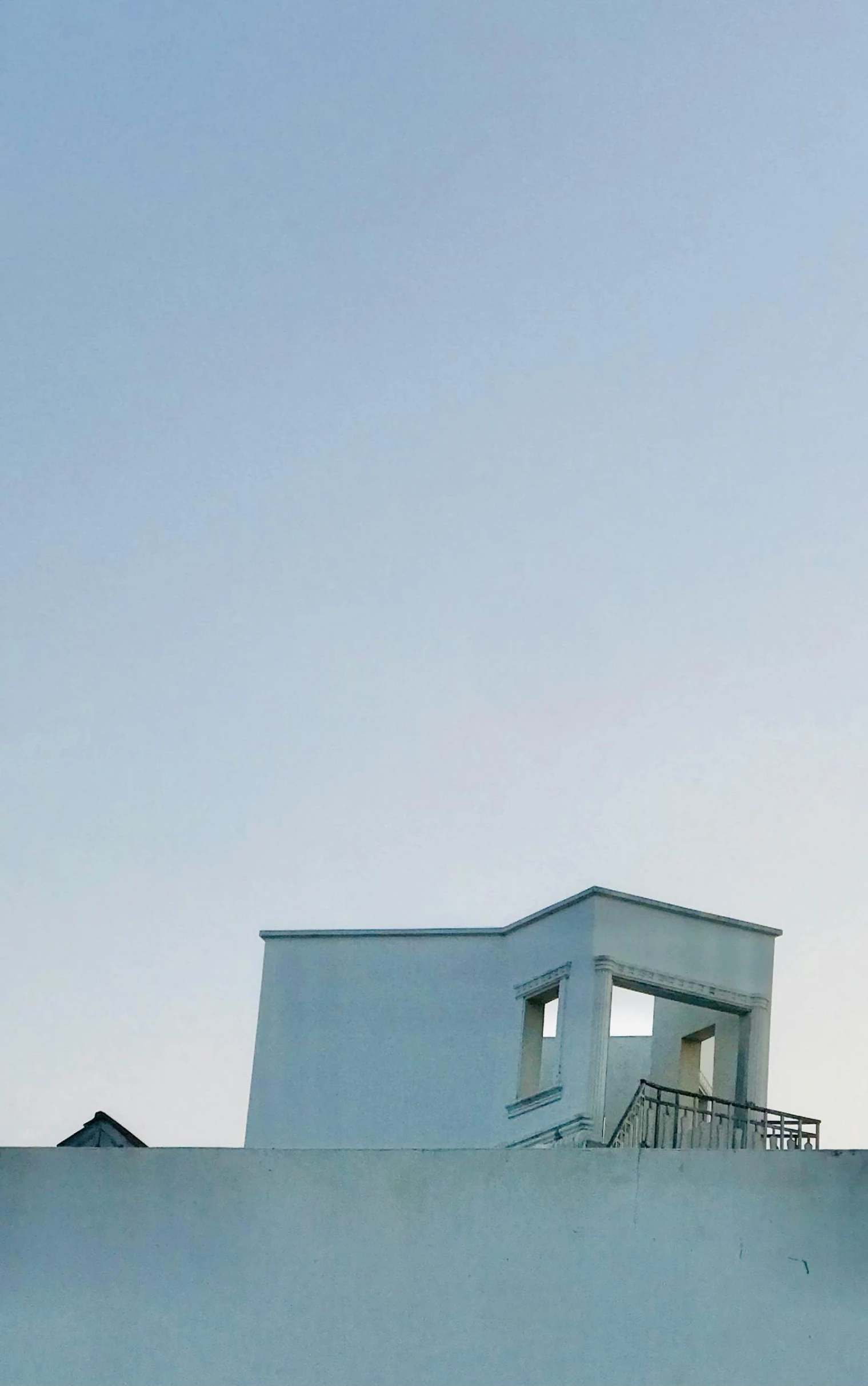 an airplane flying over a building and a clock tower