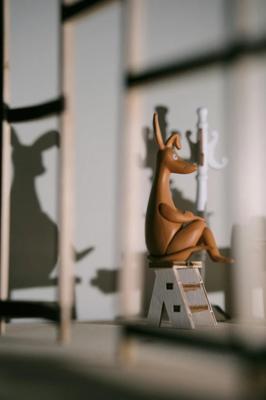 a wooden toy kangaroo is sitting on a table