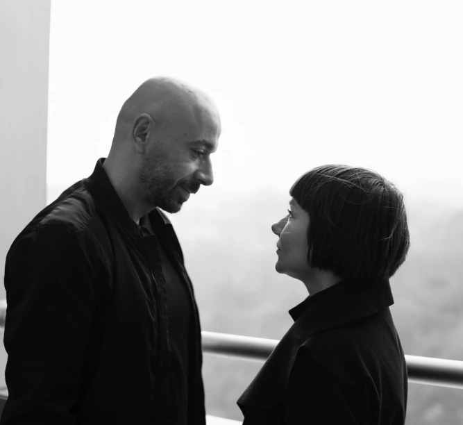 a man and woman stand near one another