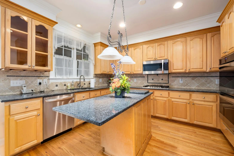 this is a kitchen with wooden cabinets and granite counters