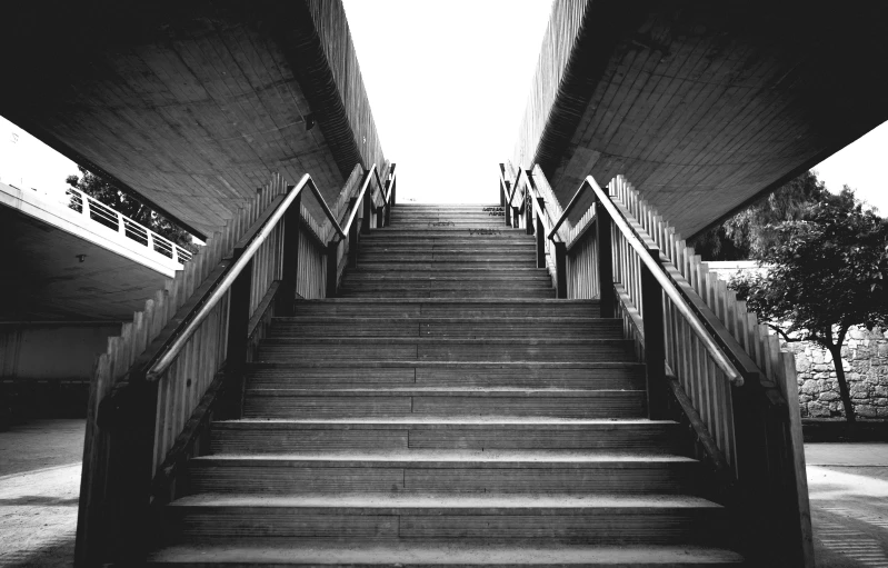 a set of stairs with two sets of hand rails