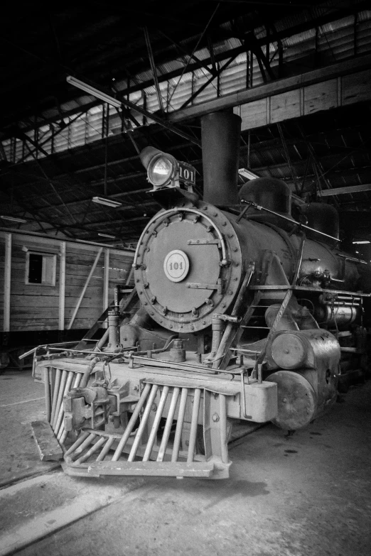 an old fashioned locomotive sitting in a train garage