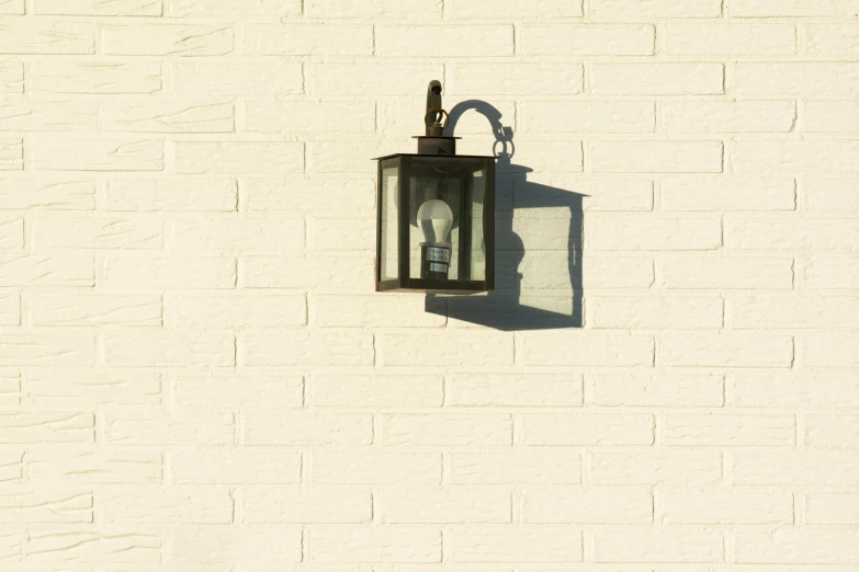 a single light wall mounted on the side of a building