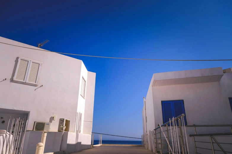 a building with a white fence and door near a street