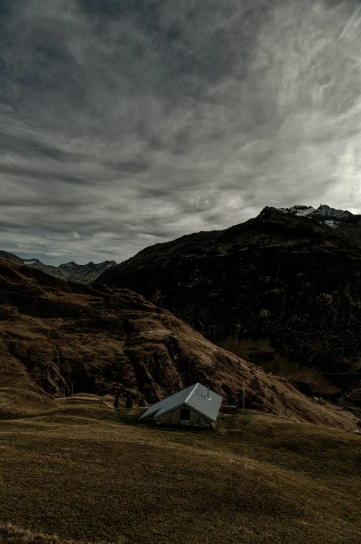 an image of some hills under a cloudy sky