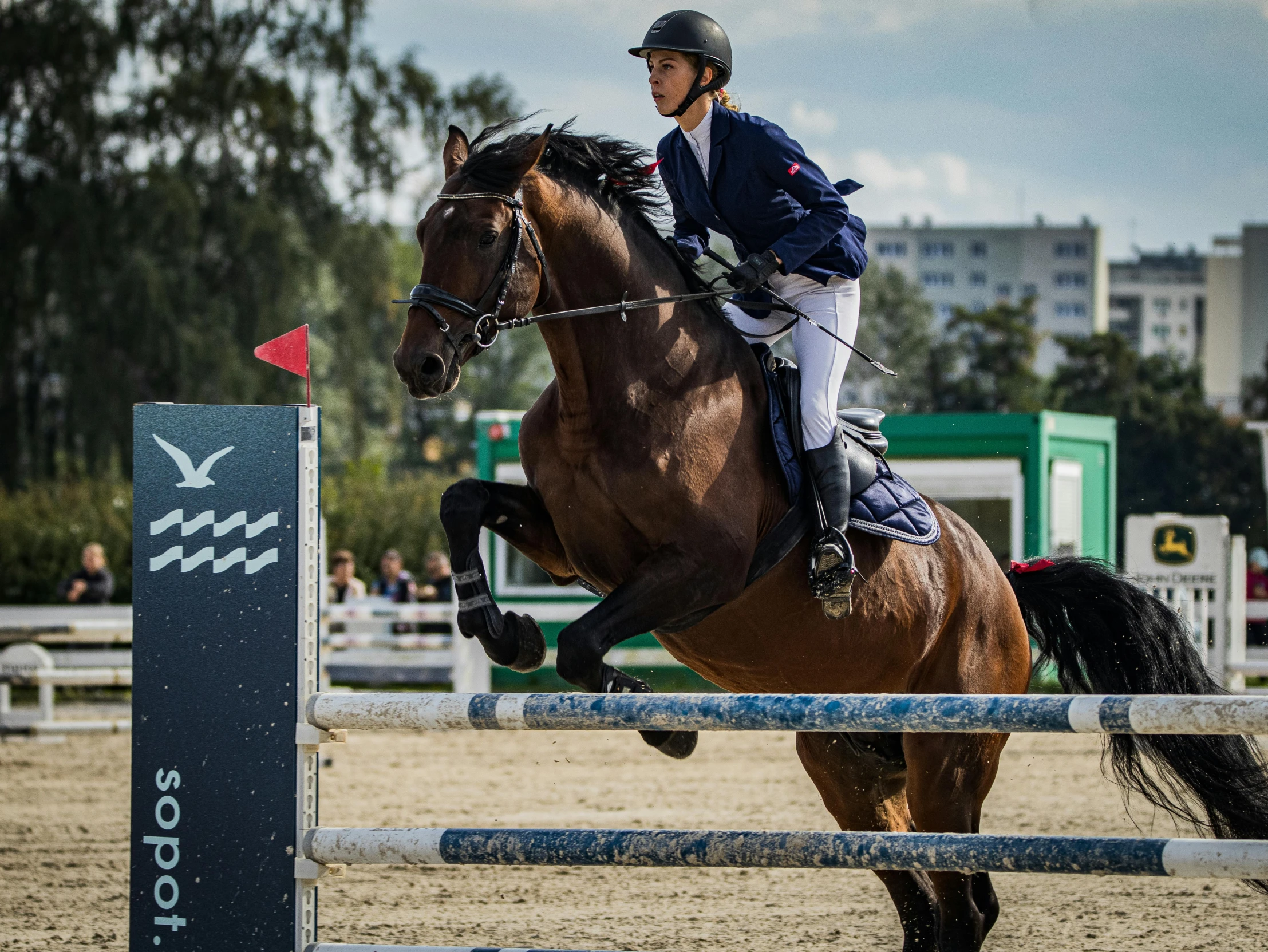 a horse jumping over an obstacle course during a competition