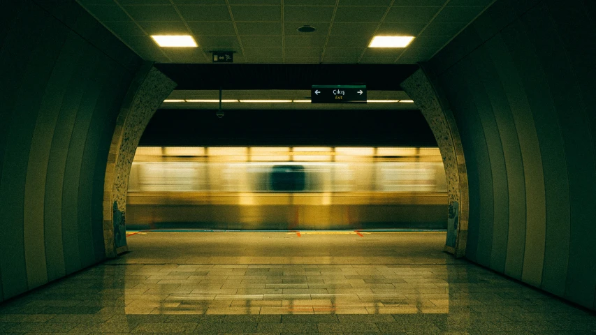 a subway is passing by a dark tunnel