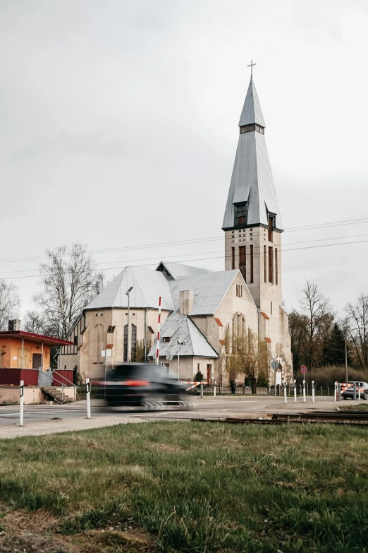 a church and a car drive down the road