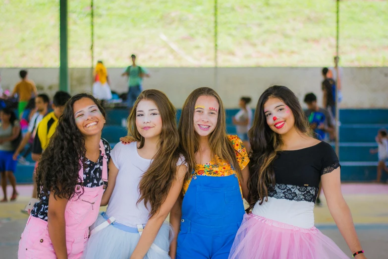 three s with frilly skirts and smiles for the camera