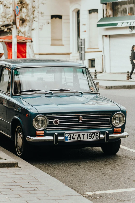 an older style station wagon is stopped at the curb