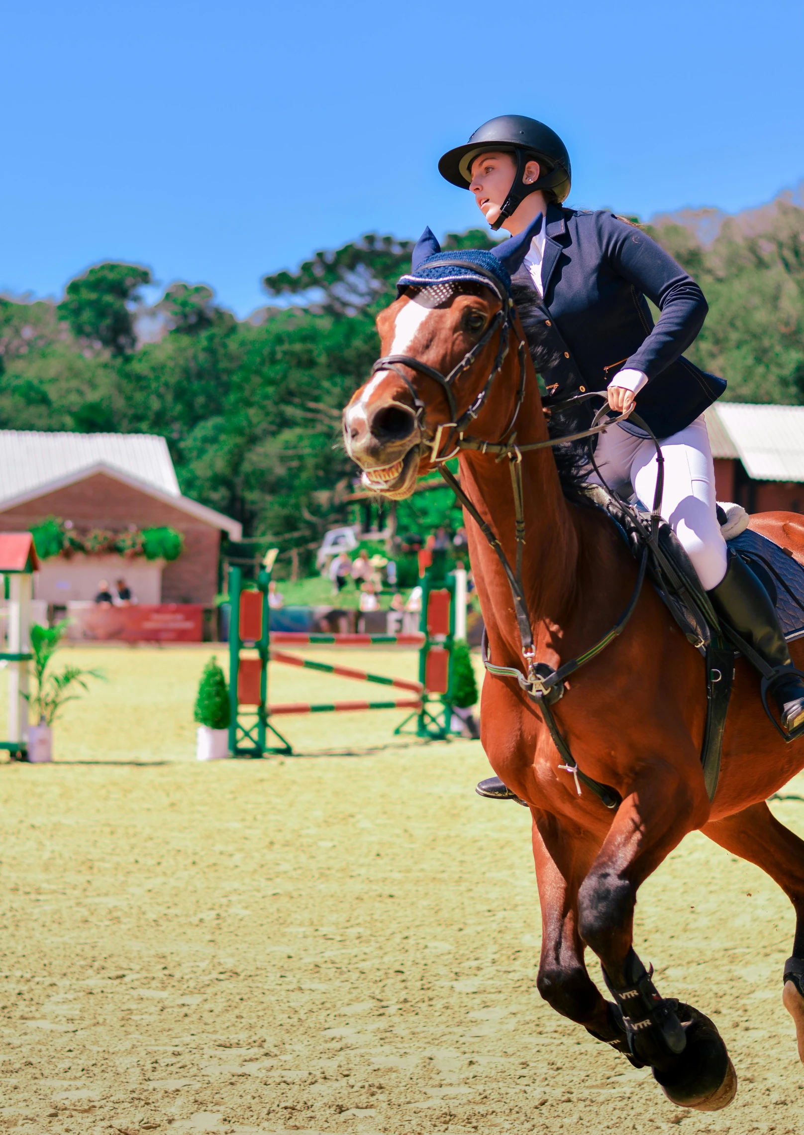 a woman on top of a brown horse while she is riding