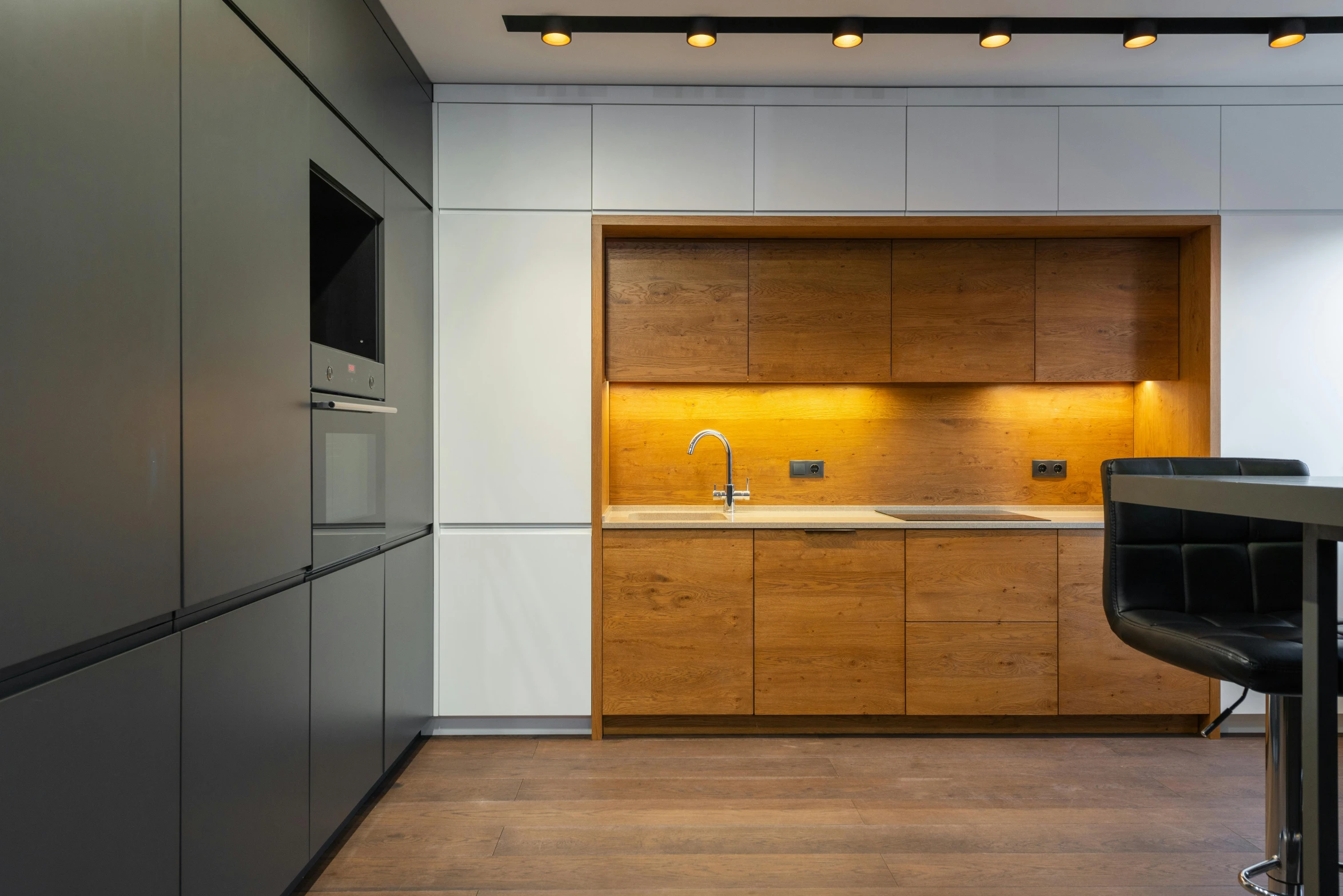 a white kitchen is open and features an oven