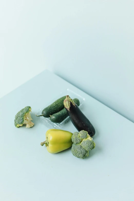 an assortment of vegetables displayed on top of a counter