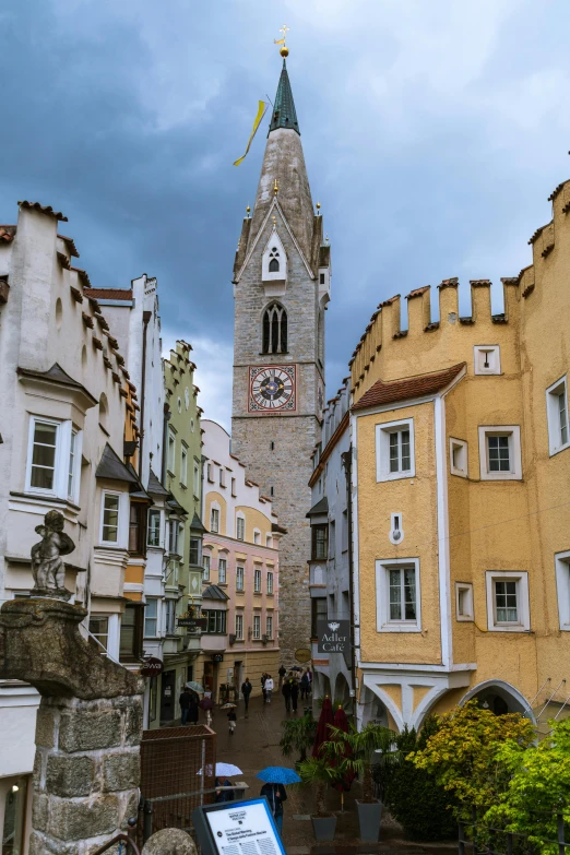 a small building with a clock tower next to buildings