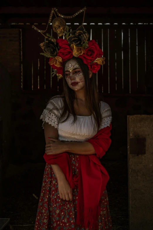 a woman with fake  on her face and a flower in her hair, dressed as a mexican day of the dead