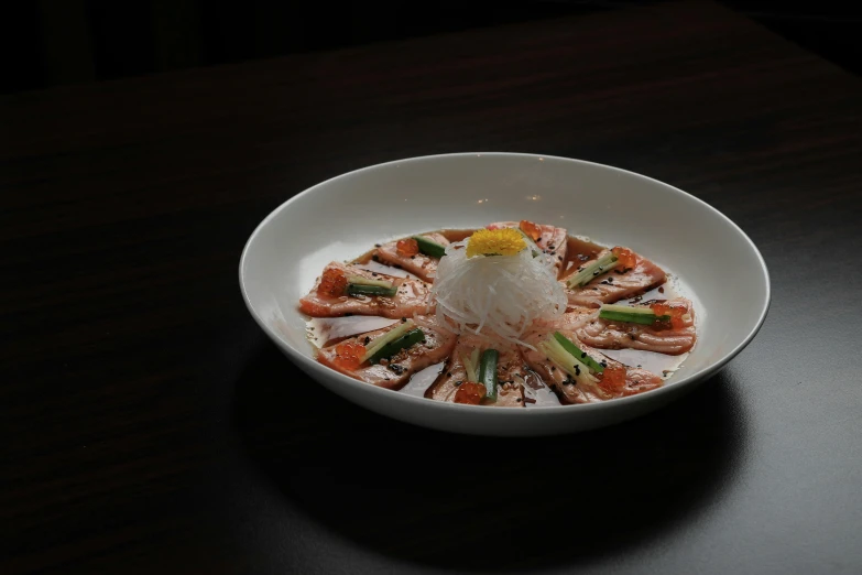 a bowl filled with vegetables, meat and sauce