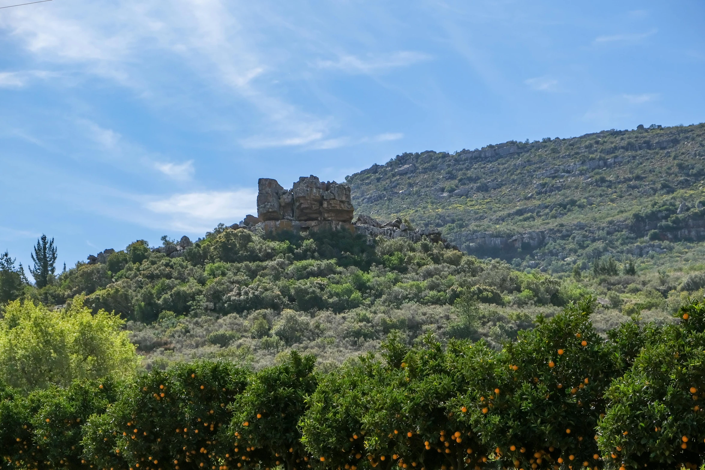 a castle is nestled on top of a hillside