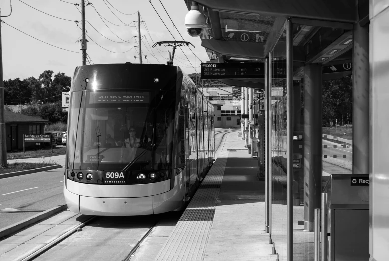 a black and white po of an electric train at the depot