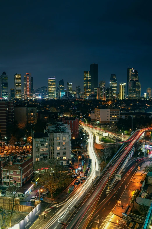 an aerial view of city skyline with light trails at night