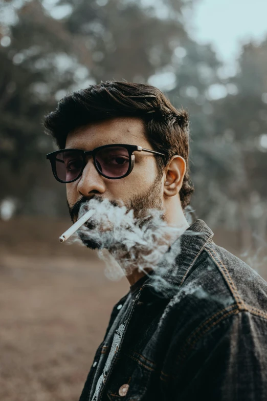 a man is smoking an electronic cigarette