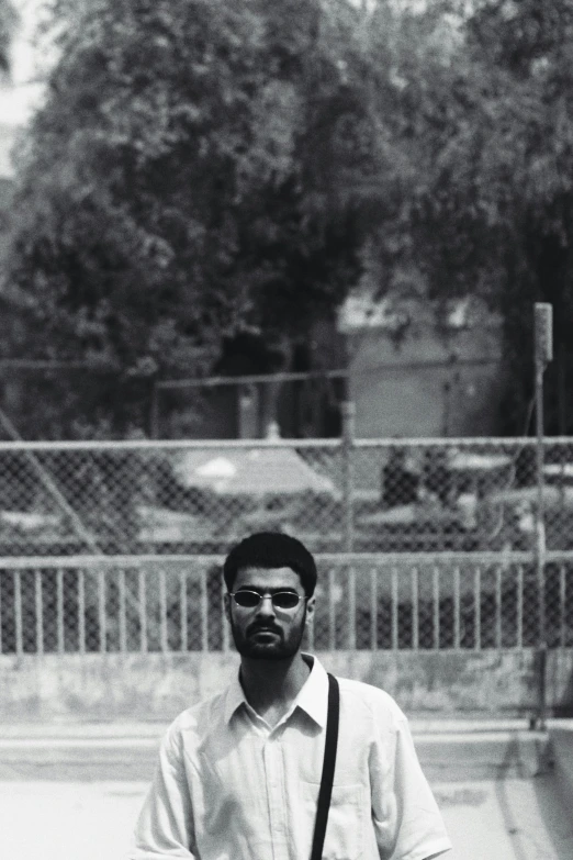 a man is standing alone with a skateboard