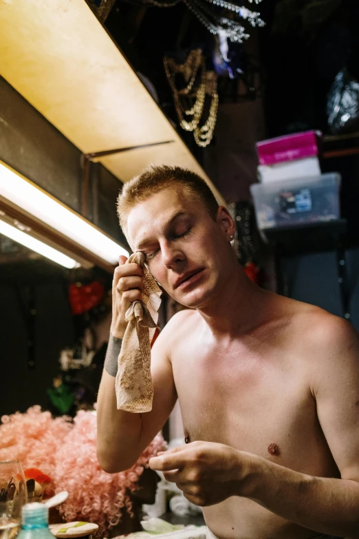 a man talks on a phone in his kitchen