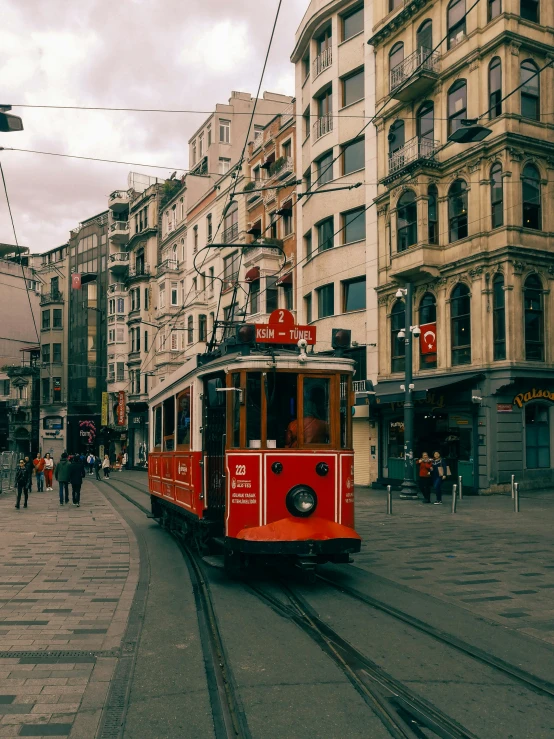 a small train on the tracks near a city street