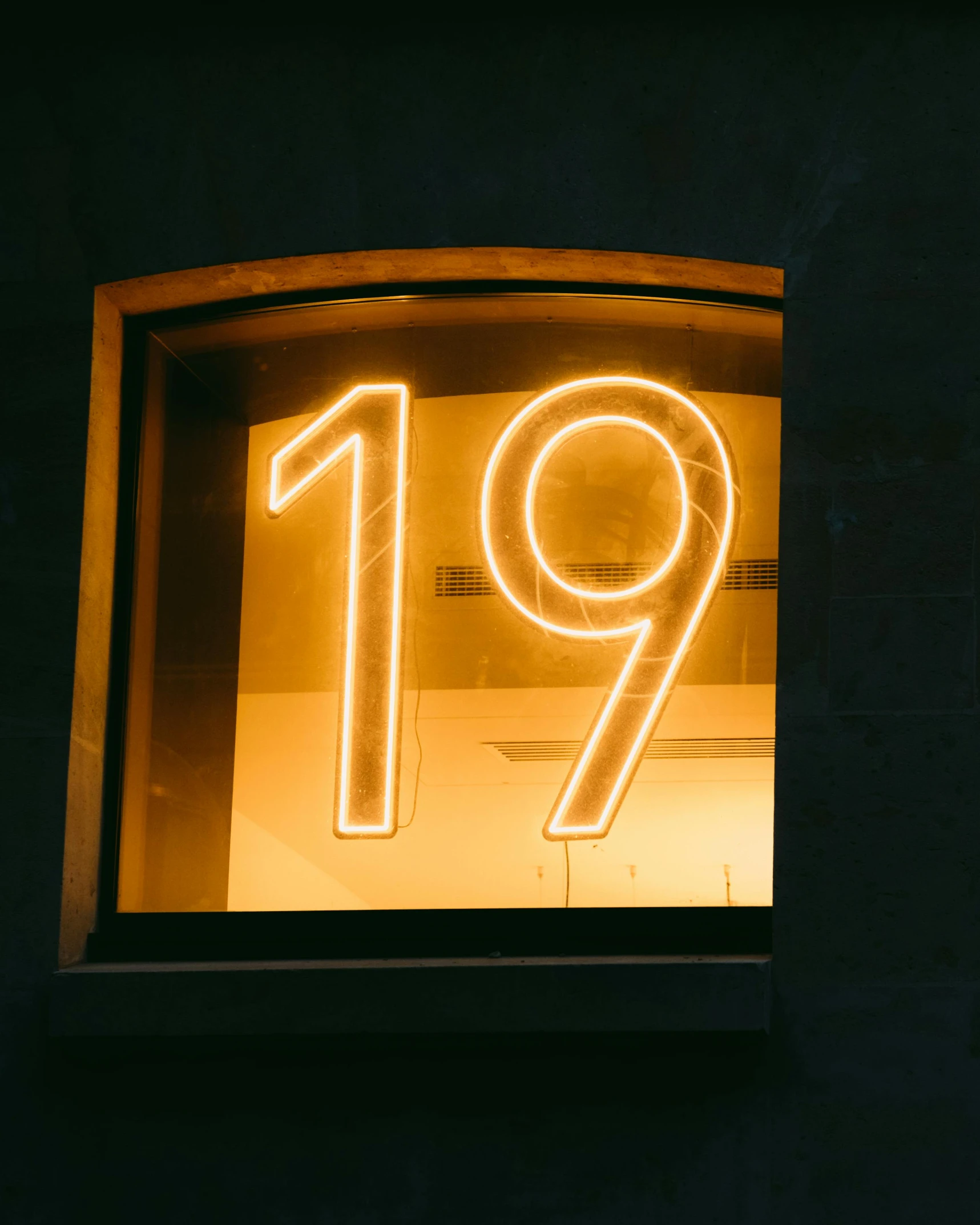 neon sign with numbers displayed in dark room