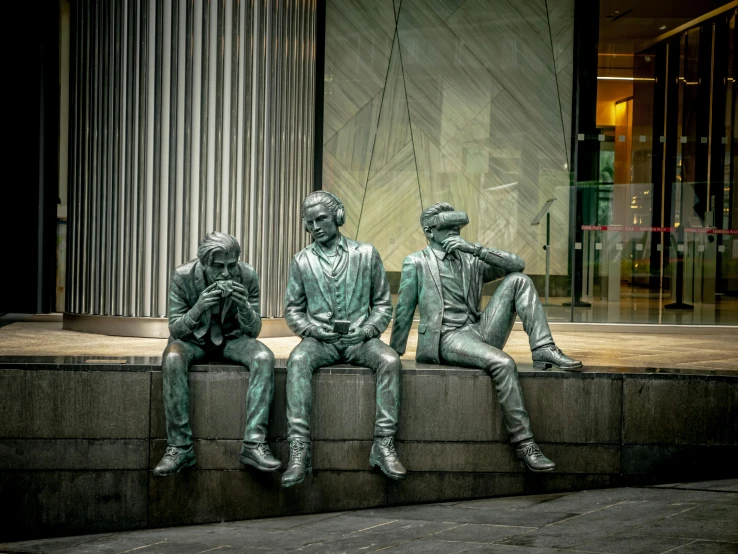 a couple of statues sitting on a stone ledge