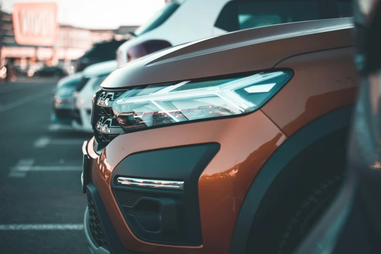 cars parked together in a lot next to each other