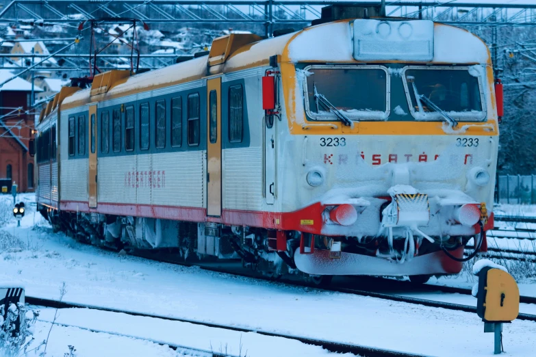 train car sitting on track in snow covered area