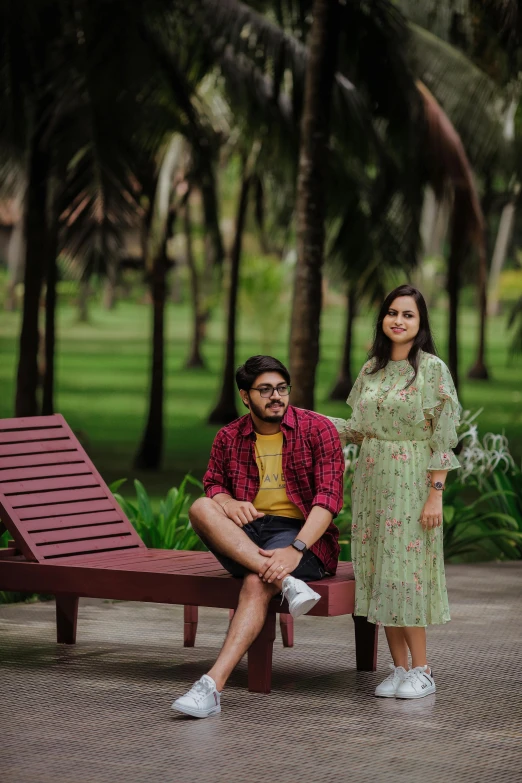 a man and a woman sitting on a bench in a park