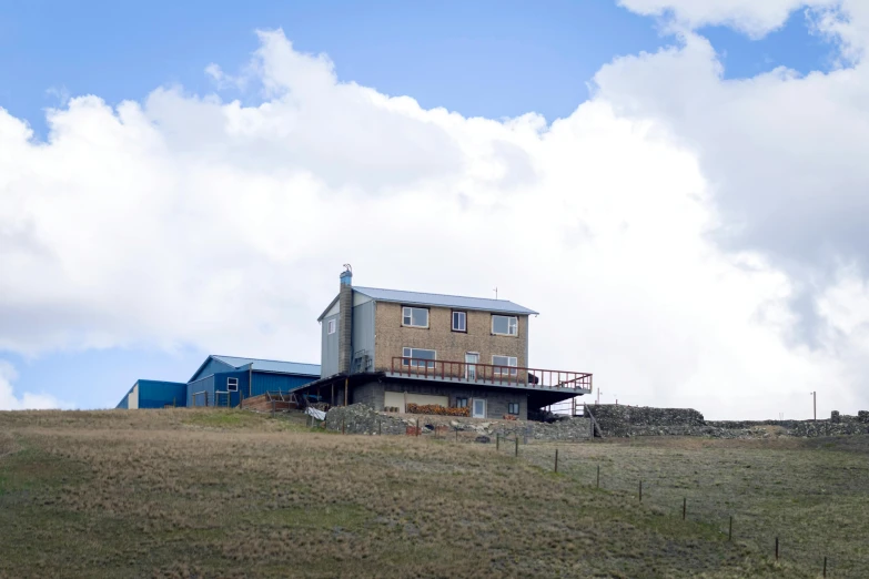 a home on top of a hill under a blue sky