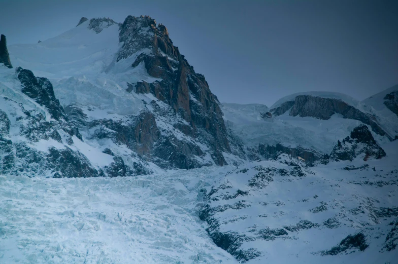 snowy mountain peaks are seen from the top of a ski slope