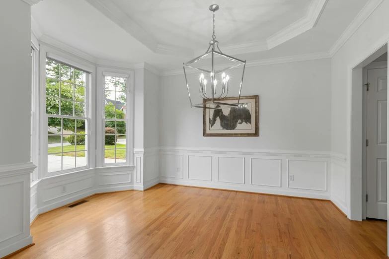 a room with a large wooden floor and lots of windows