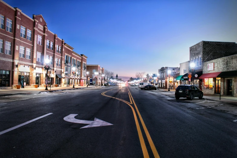 a street with cars and streetlights on both sides