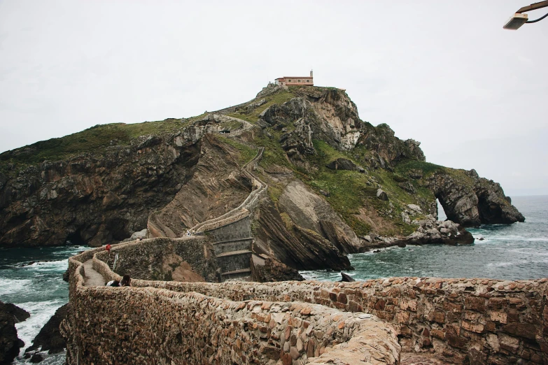 a stone stairway over the ocean near an island