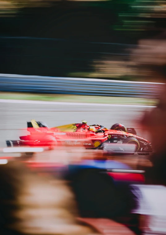 a person on a red race car going around the track