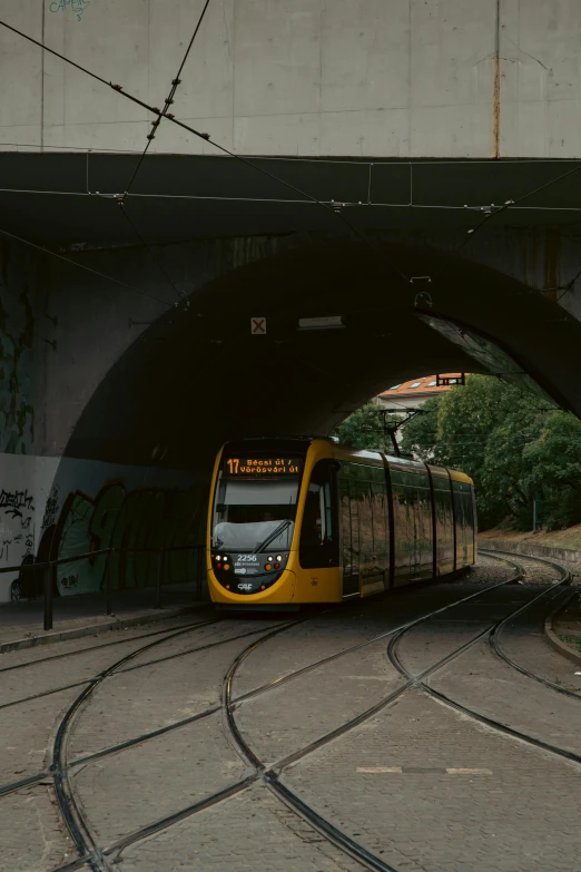 a train traveling under a tunnel during the day