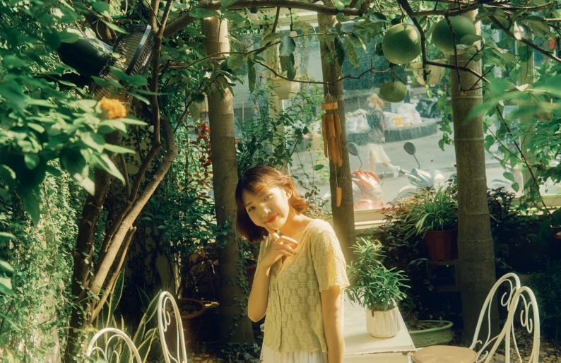 woman brushing her teeth in a patio with several trees