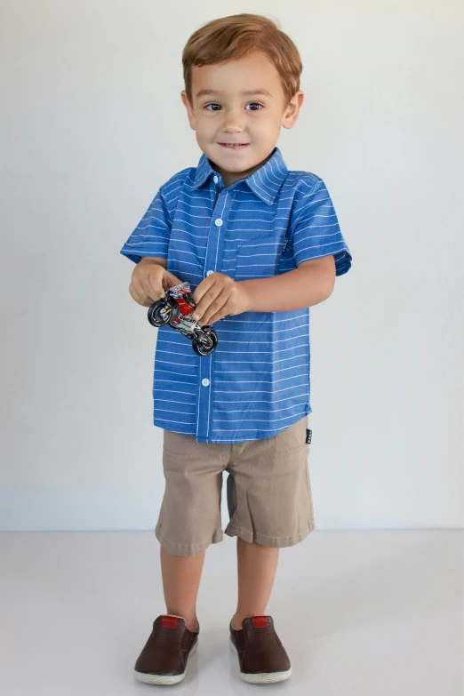 a little boy that is smiling while standing up