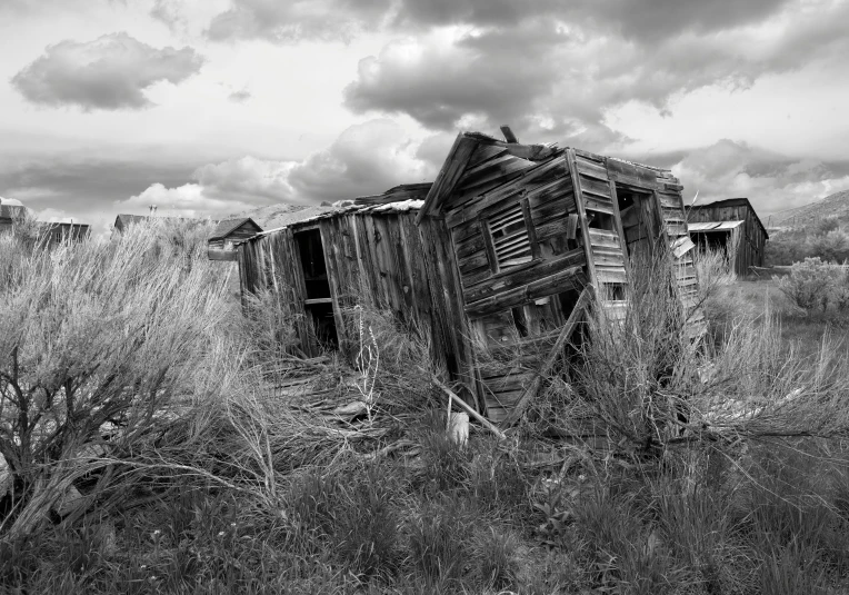 an old abandoned shack is sitting in a field