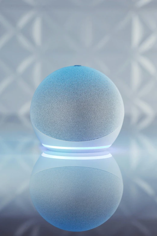 the blue, modern speaker sits on a surface